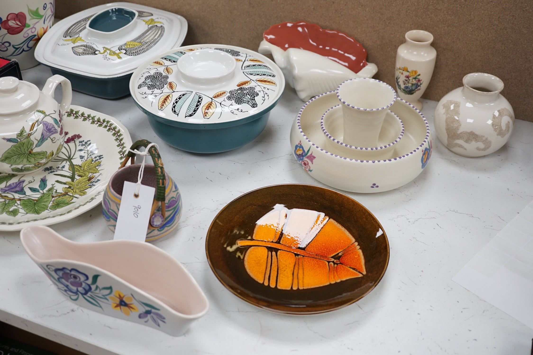 A collection of Poole pottery teapots, plates etc.